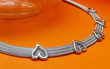 Picture of “Herringbone heart” necklace entirely in Italian sterling silver, flat herringbone decorated with polished hearts