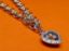 Afbeeldingen van “Speelse” armband in sterling zilver, rolo schakel ketting met hartvormig bedeltje omringd door kubiek zirkonia en daarin zwevende zirkonia