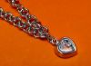 Picture of “Playful” bracelet in sterling silver, rolo link chain with heart charm outlined with cubic zirconia and containing floating zirconia