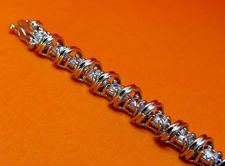 Picture of “Spiraling in Zirconia ” tennis bracelet in sterling silver, a row of prong set round cubic zirconia interspersed with spiraling waves