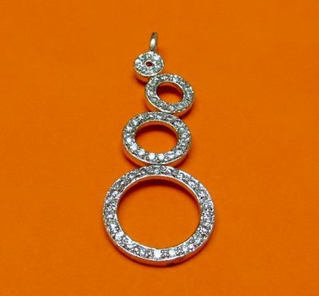Picture of “Zirconia circles” pendant in sterling silver with off-center circles encrusted with round cubic zirconia