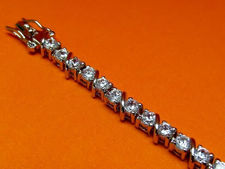Picture of “Zirconia Slash Zirconia” tennis bracelet in sterling silver, a row of prong set round cubic zirconia interspersed with forward slashes