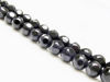 Picture of 8x8 mm, round, gemstone beads, onyx, black, large shiny facets on a frosted round background