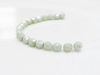 Picture of 3x3 mm, Czech faceted round beads, chalk white, opaque, light celadon green luster