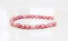 Picture of 4x4 mm, Czech faceted round beads, chalk white, opaque, light topaz pink luster