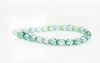 Picture of 4x4 mm, Czech faceted round beads, transparent, light emerald green shimmering