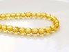 Picture of 4x4 mm, Czech faceted round beads, honey yellow, transparent, pre-strung