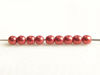 Picture of 3x3 mm, round, Czech druk beads, samba red, opaque, sueded gold