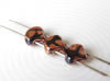 Picture of 7.5x7.5 mm, fan-shaped beads, Ginkgo leaf, Czech glass, 2 holes, opaque, black, Apollo bronze finishing